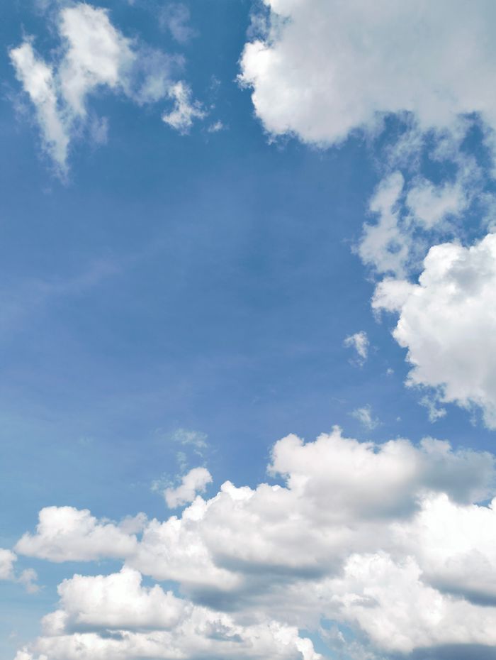Home Bright blue sky filled with fluffy white clouds, capturing the essence of a sunny day.